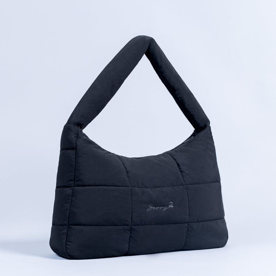 Sav puffer bag in dark navy with short top handles and quilted panel design