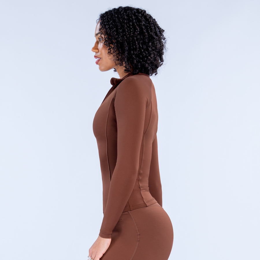Brown fitted athletic bodysuit, side view, long sleeves and front zipper