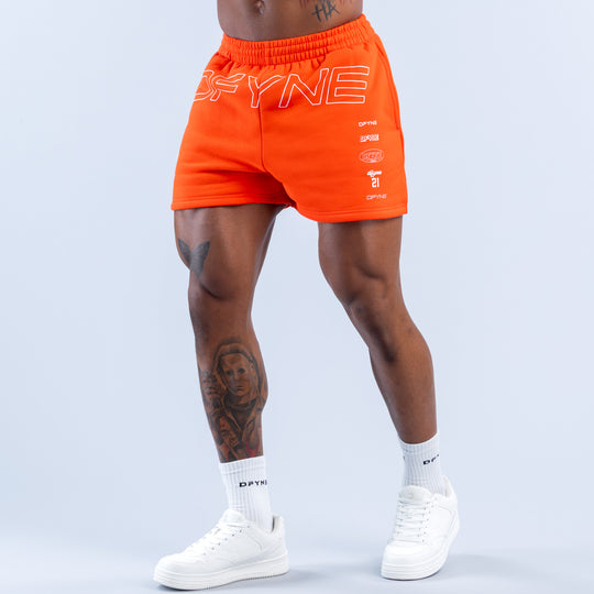 Orange jogger shorts with 'OFYNE' graphic, elastic waistband, front logo print