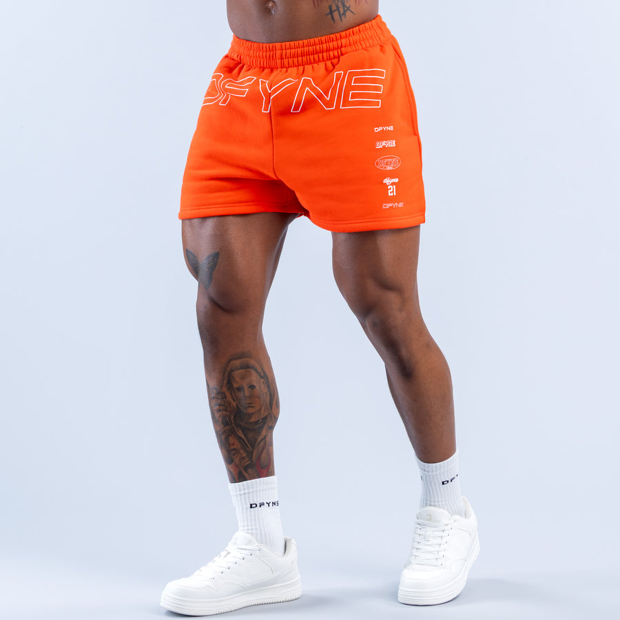 Orange jogger shorts with 'OFYNE' graphic, elastic waistband, front logo print