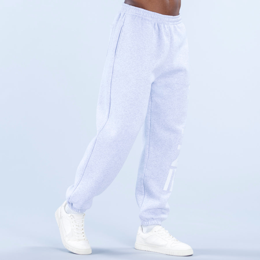 Light blue heather jogger pants with elastic waistband, tapered legs, side logo graphic