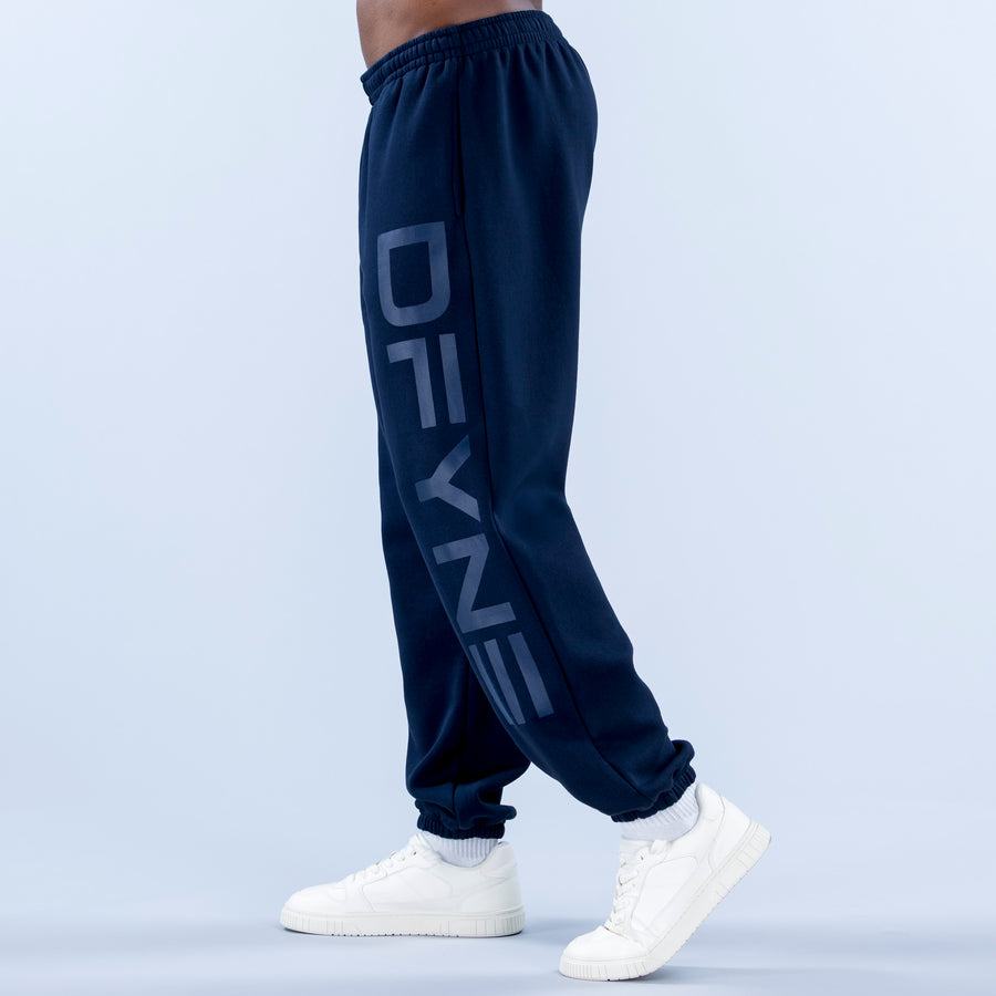Navy cuffed joggers with elastic waistband and large angled side logo graphic