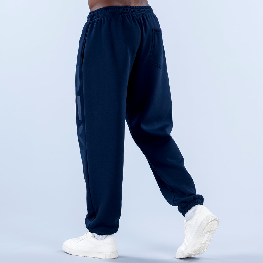 Navy cuffed joggers with elastic waistband and side graphic panel detail
