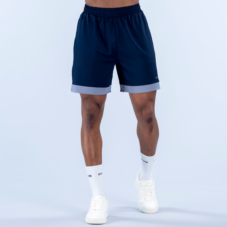 Navy jersey shorts with elastic waistband and light gray contrast hem