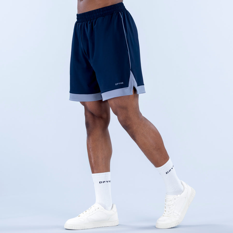 Navy jersey shorts with elastic waistband, side seam, light gray hem panel
