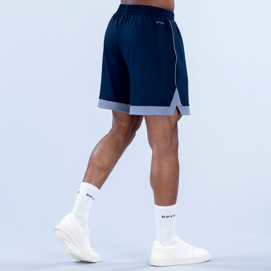 Navy jersey shorts from the side with elastic waistband and light gray contrast hem