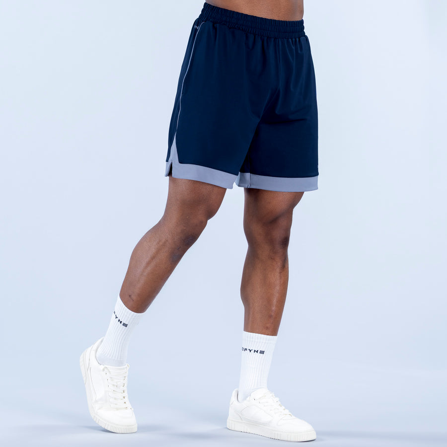 Navy jersey shorts, back view, elastic waistband, light gray hem panel