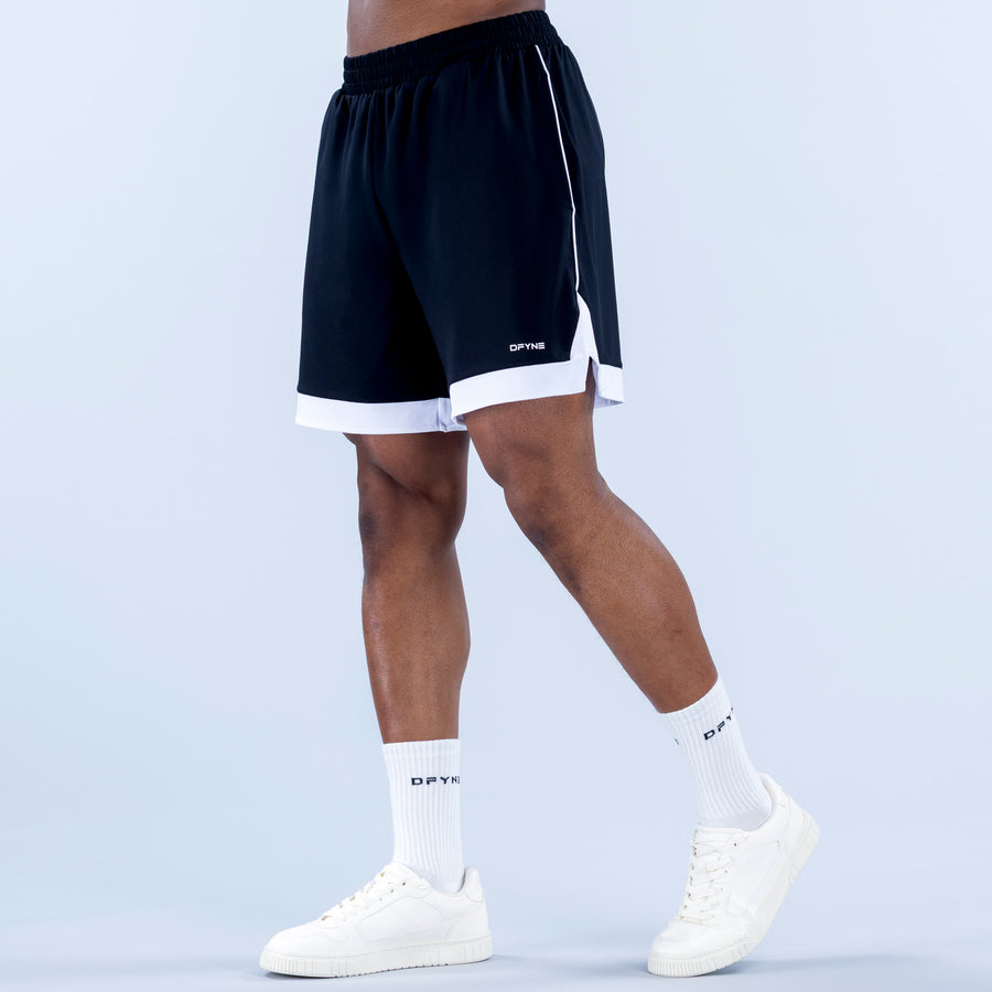 Navy jersey shorts with elastic waistband, white hem, and side logo detail
