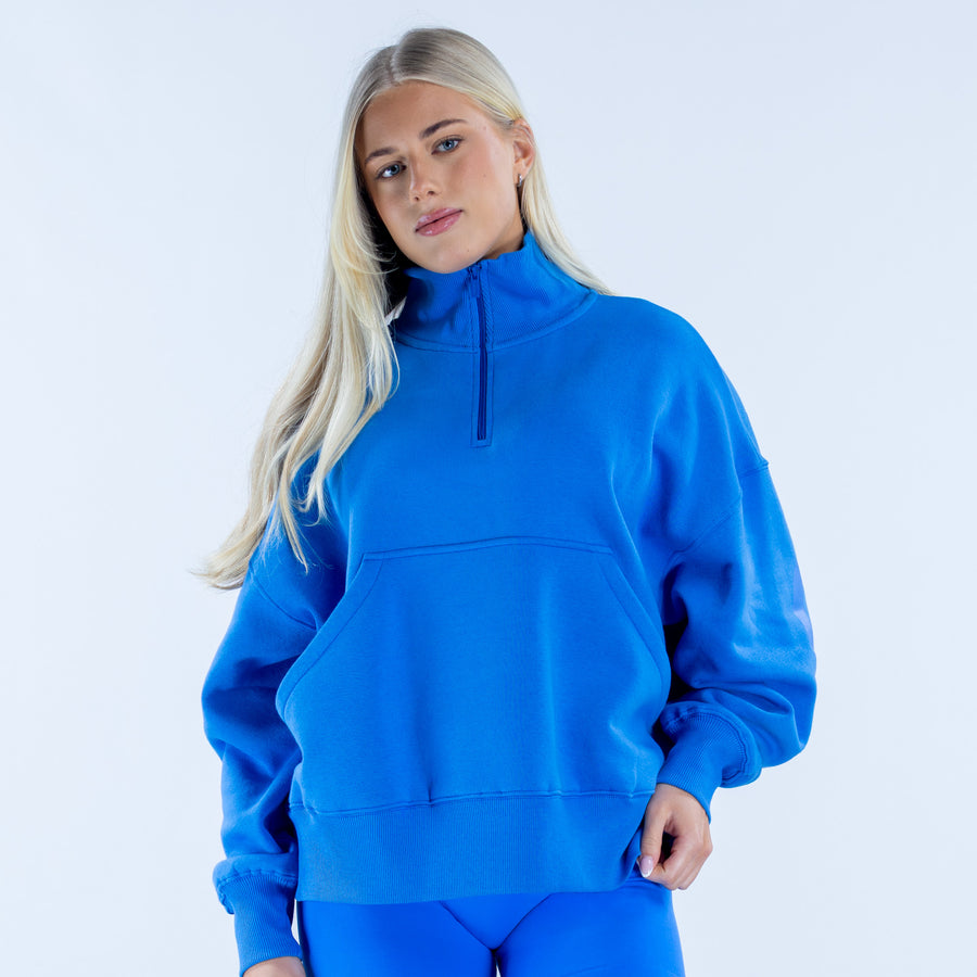 Quarter-zip sweatshirt in bright blue with front half-zip and kangaroo pocket