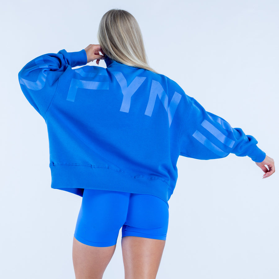 Quarter-zip sweatshirt in bright blue, kangaroo pocket; back view
