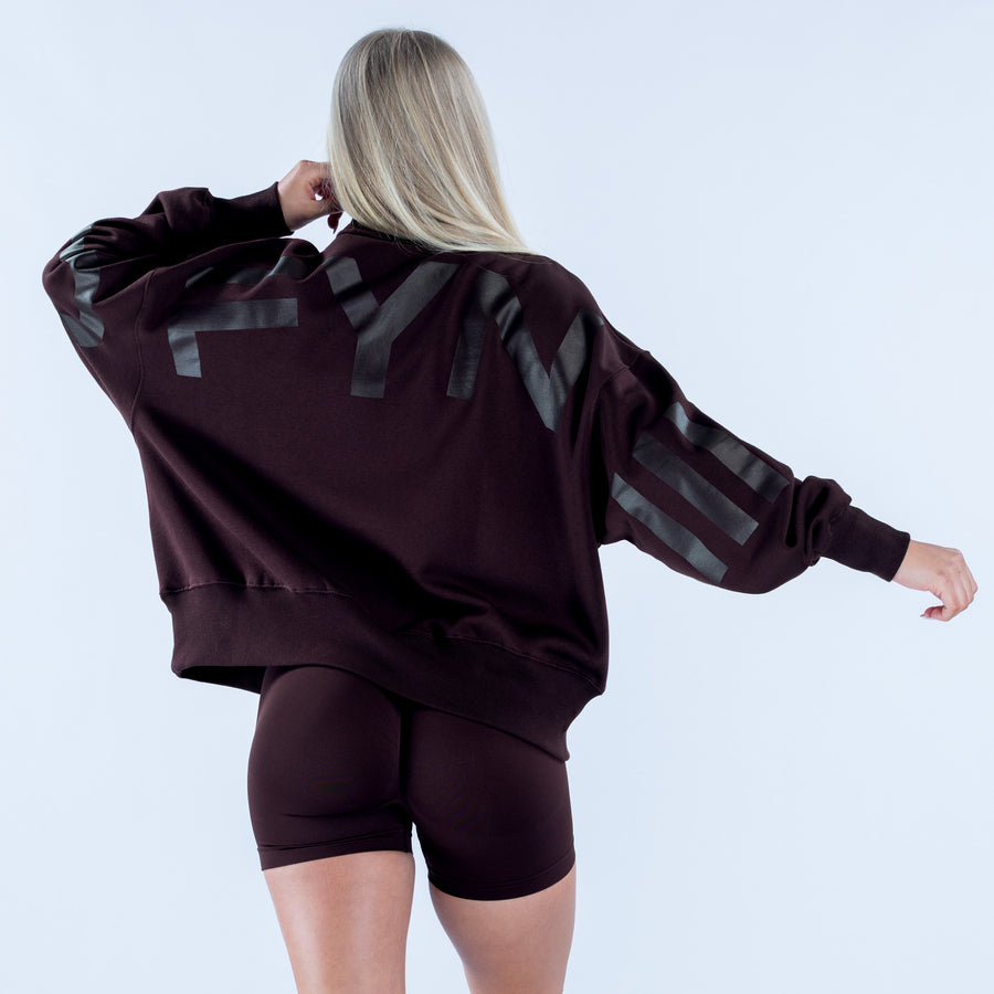 Quarter zip sweatshirt, dark burgundy back with gray plaid sleeve stripes and ribbed hem