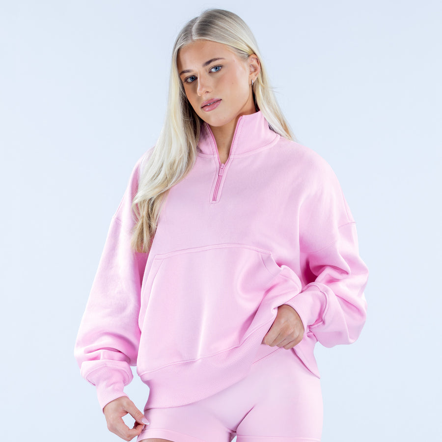 Pink quarter-zip sweatshirt with zip-up collar and kangaroo-style pocket