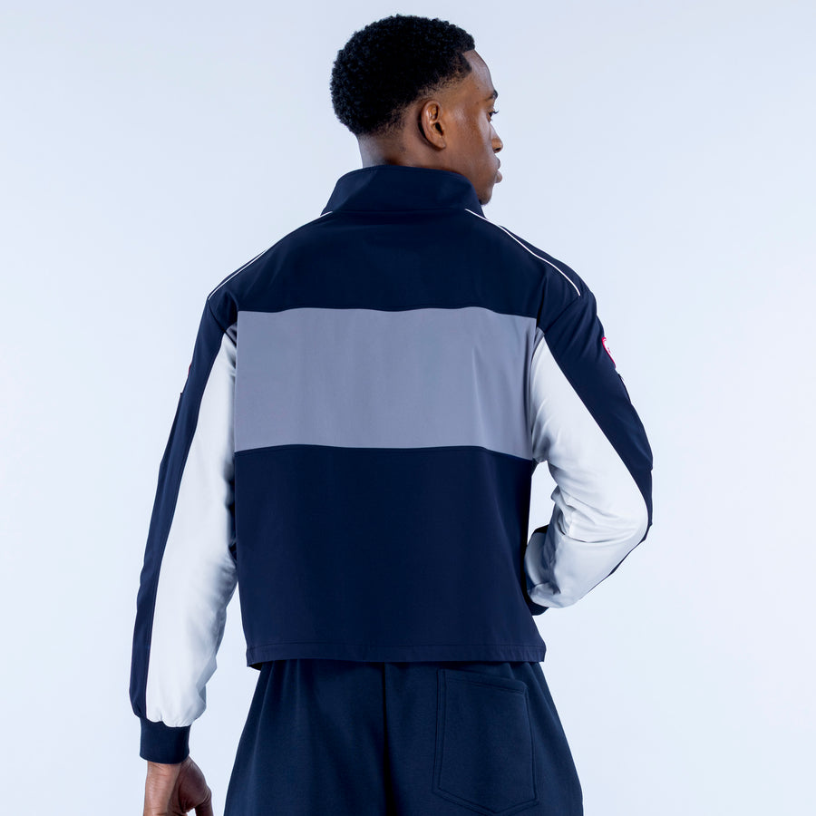 Two-tone track jacket, back view; navy and light gray color blocks, full-zip collar