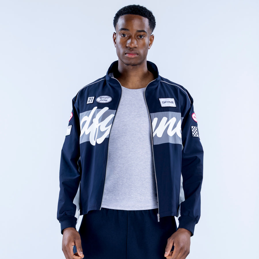 Two-tone track jacket with full zipper; navy and gray panels, open front over gray shirt
