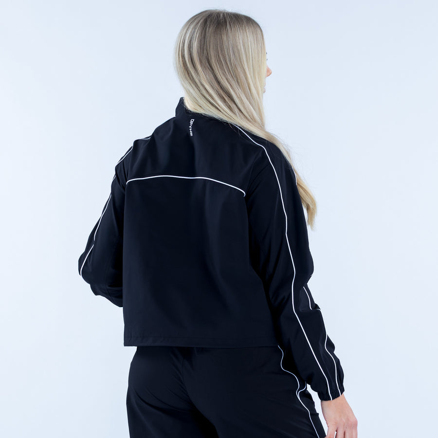 Black track jacket back view with white contrast piping and elastic cuffs
