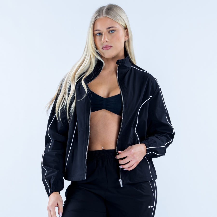 Black track jacket with white piping, zip-up front, side pockets