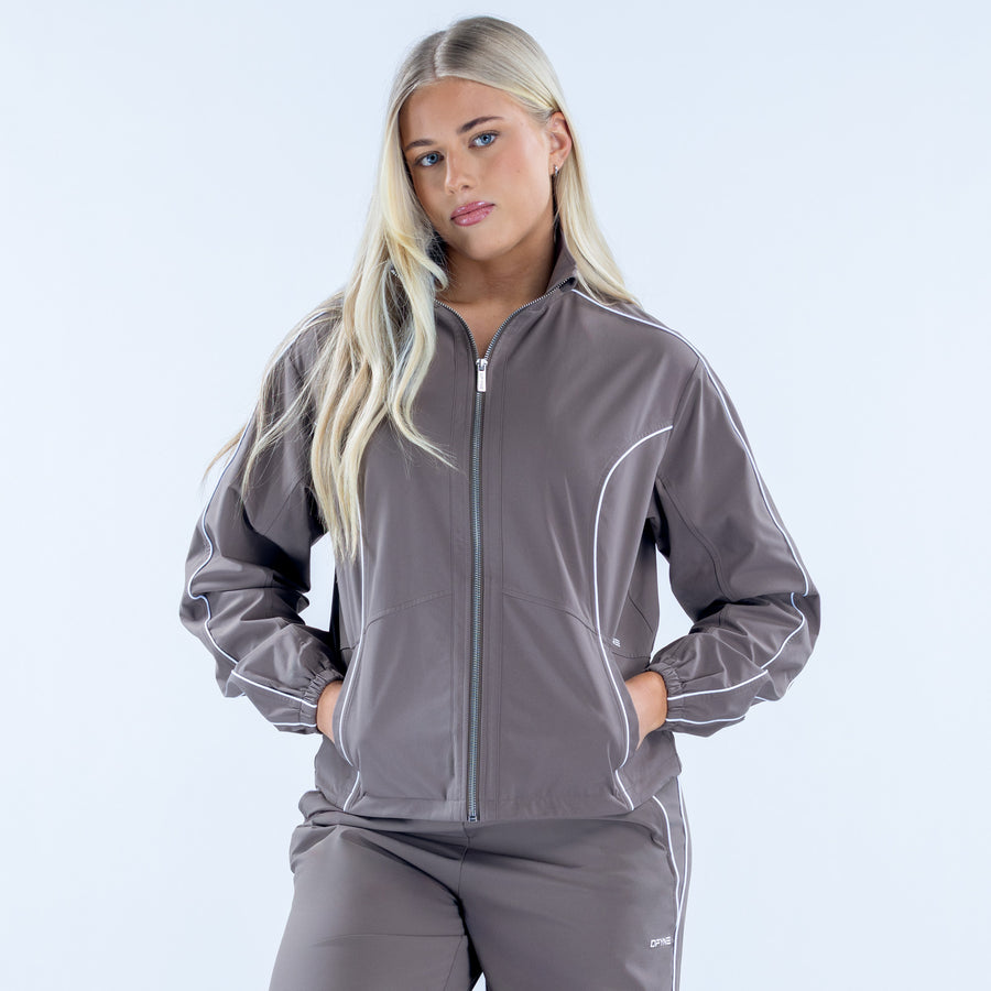 Dark gray zip track jacket with white piping, standing collar, and pockets