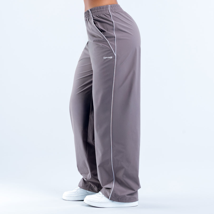 Gray track pants with white vertical stripe and elastic waistband