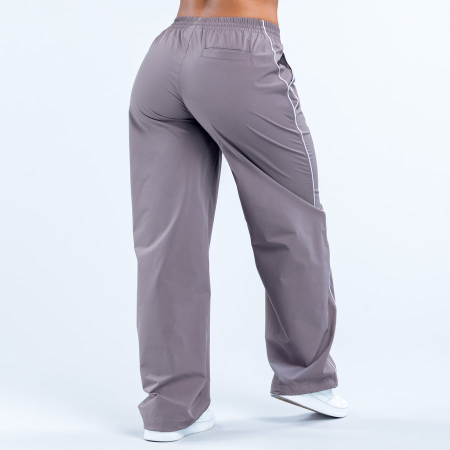 Gray track pants with elastic waistband and side pocket openings