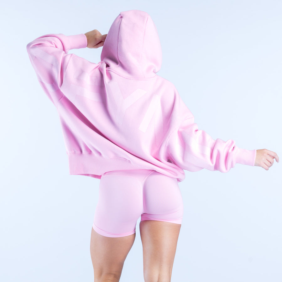Pink pullover hoodie with hood up, drawstrings, kangaroo pocket and long sleeves