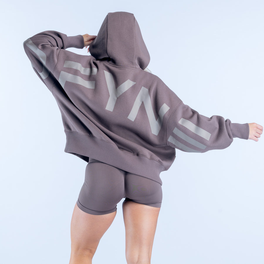 Dark taupe hoodie with hood up and large light graphic print on back