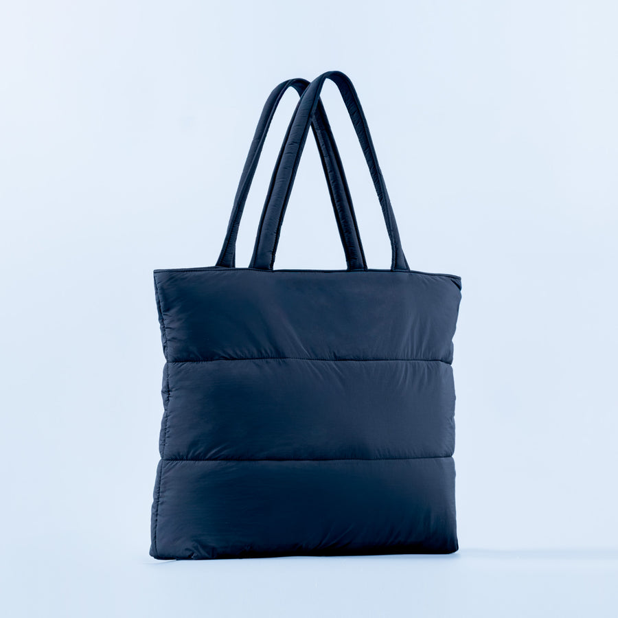 Dark blue puffer tote bag with two top handles and quilted body