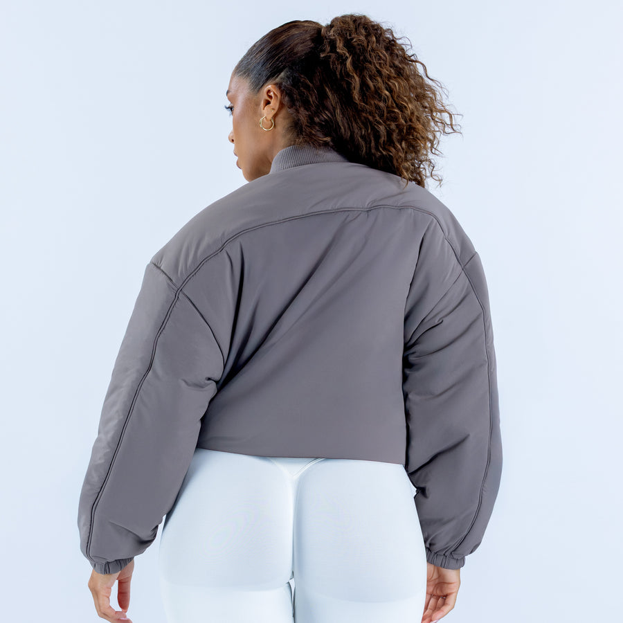 Reversible bomber jacket in gray, back view with ribbed cuffs and hem