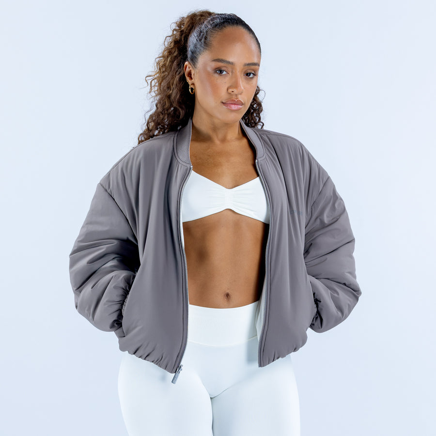 Reversible bomber jacket in gray, front view with open zipper and ribbed hem