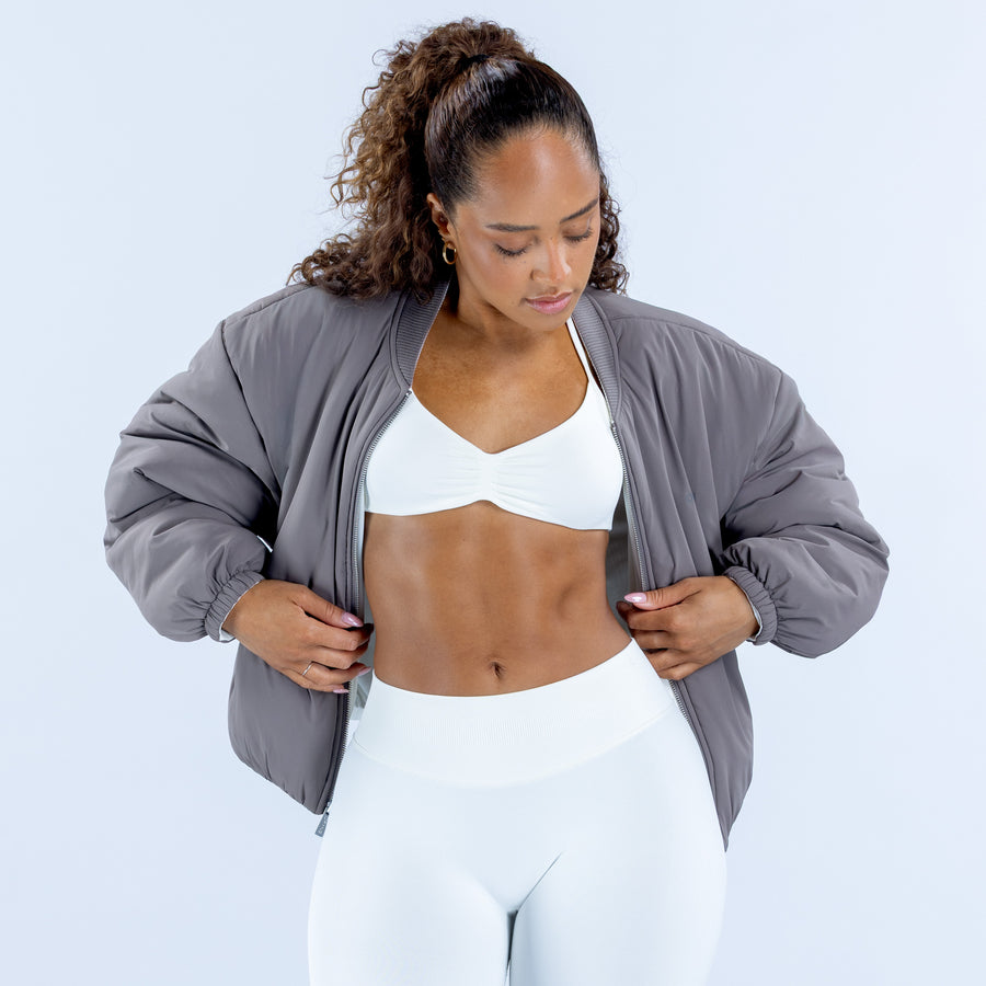 Reversible bomber jacket in gray, front view with open zipper and elastic cuffs