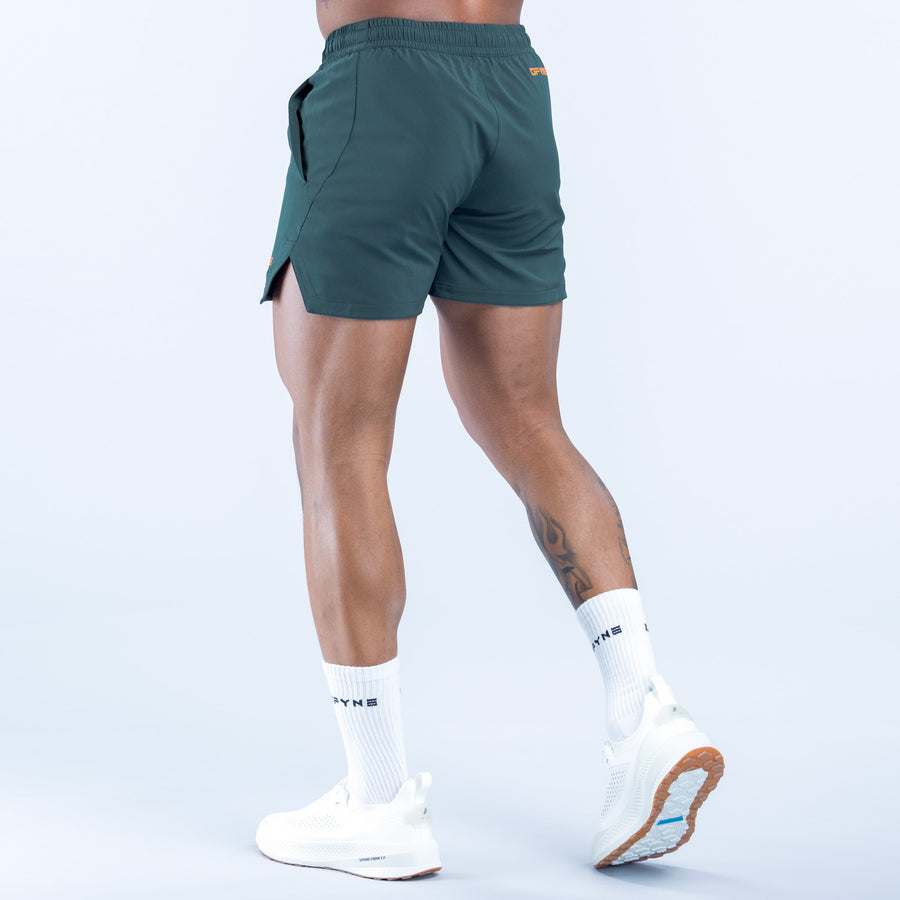 Dark green training shorts with side pockets and drawcord, back view