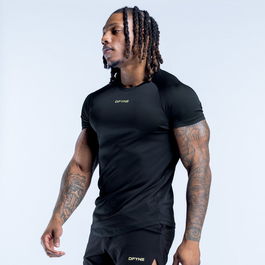 Black crew-neck training t-shirt with short sleeves and chest logo, side view.