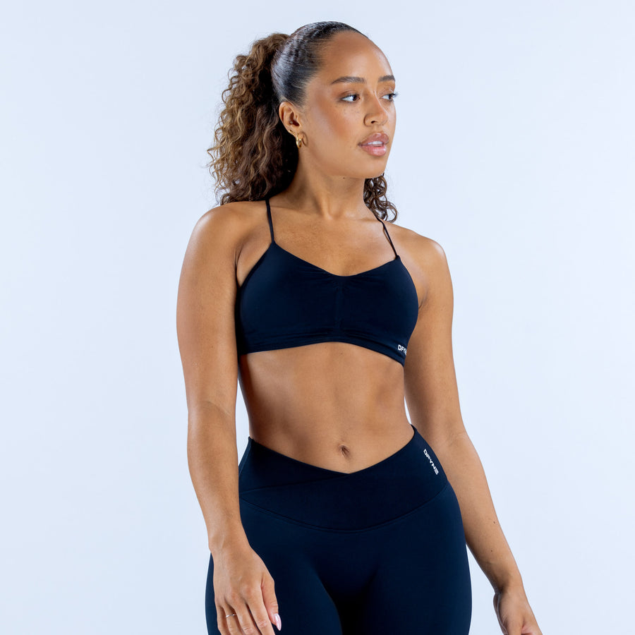 Dark navy sports bra with thin adjustable straps and scoop neckline