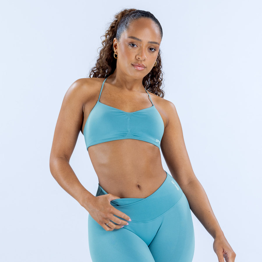 Vision sports bra in turquoise, thin spaghetti straps and straight hem