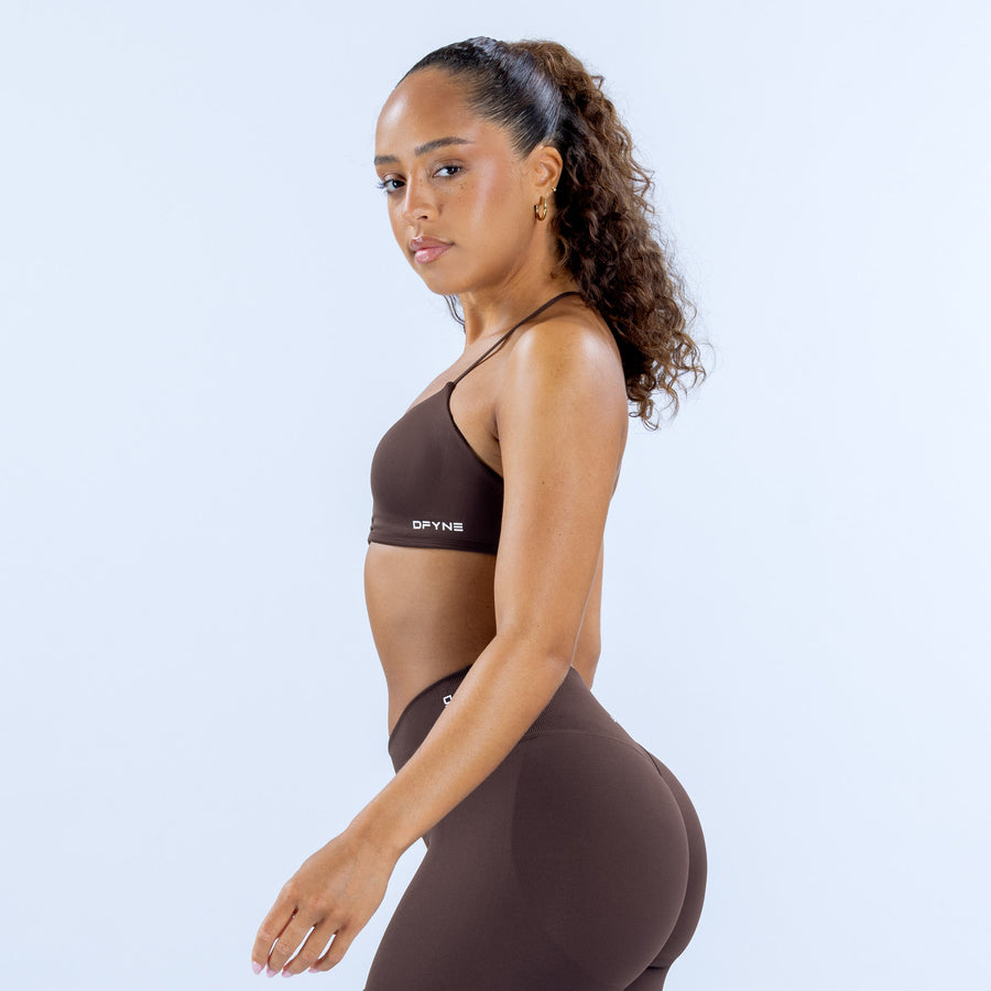 Brown sports bra with racerback straps and DPYNE logo