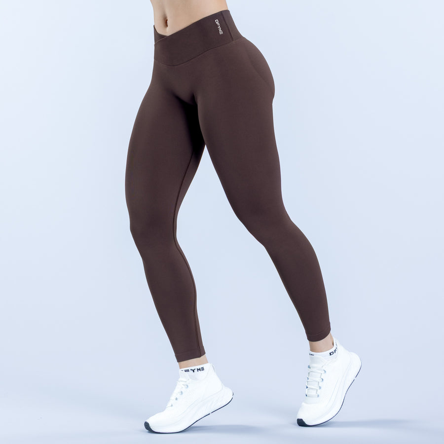 Brown high-rise compression leggings with smooth seams and small front logo