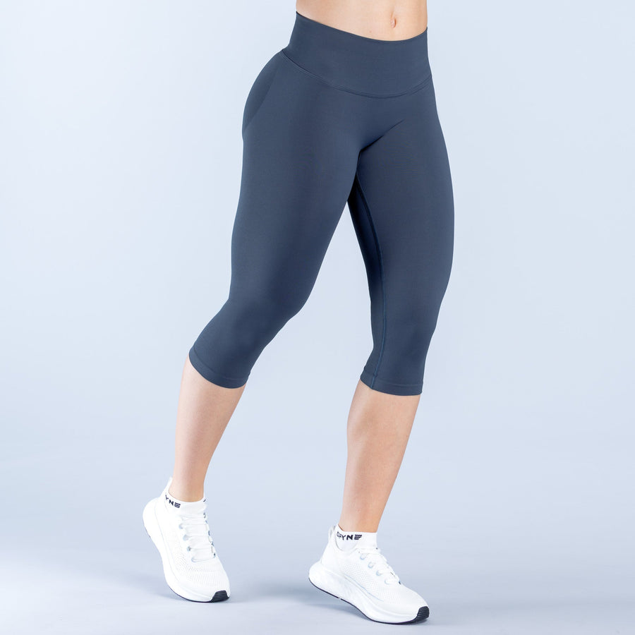 Dark navy mid-calf leggings with straight waistband and smooth stretch fit