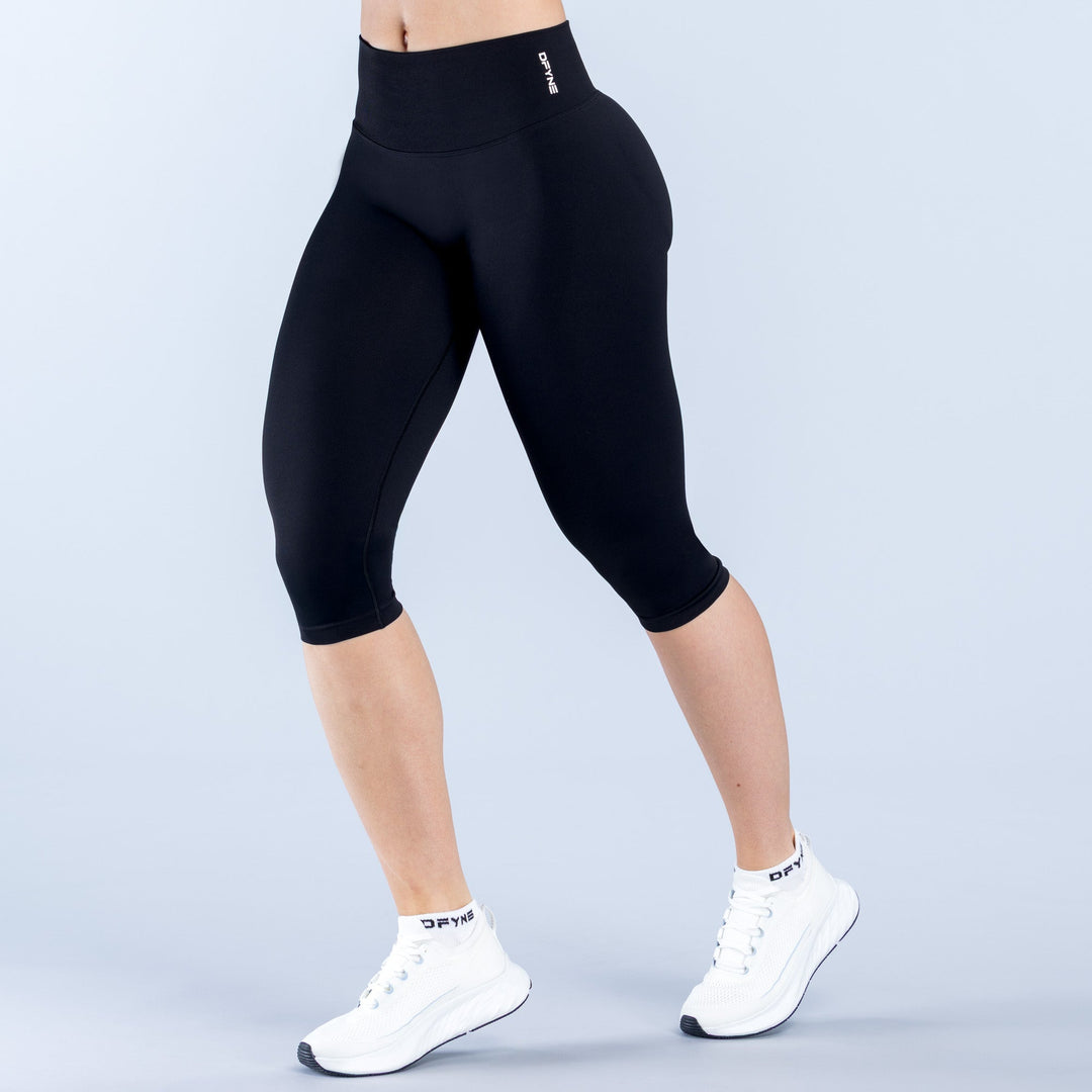 Black straight-waistband capri leggings, 3/4 length with slim fitted legs.