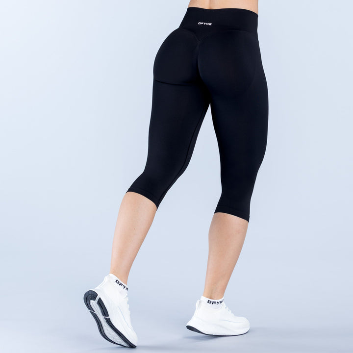 Black 3/4 capri leggings with straight waistband and smooth fitted legs.