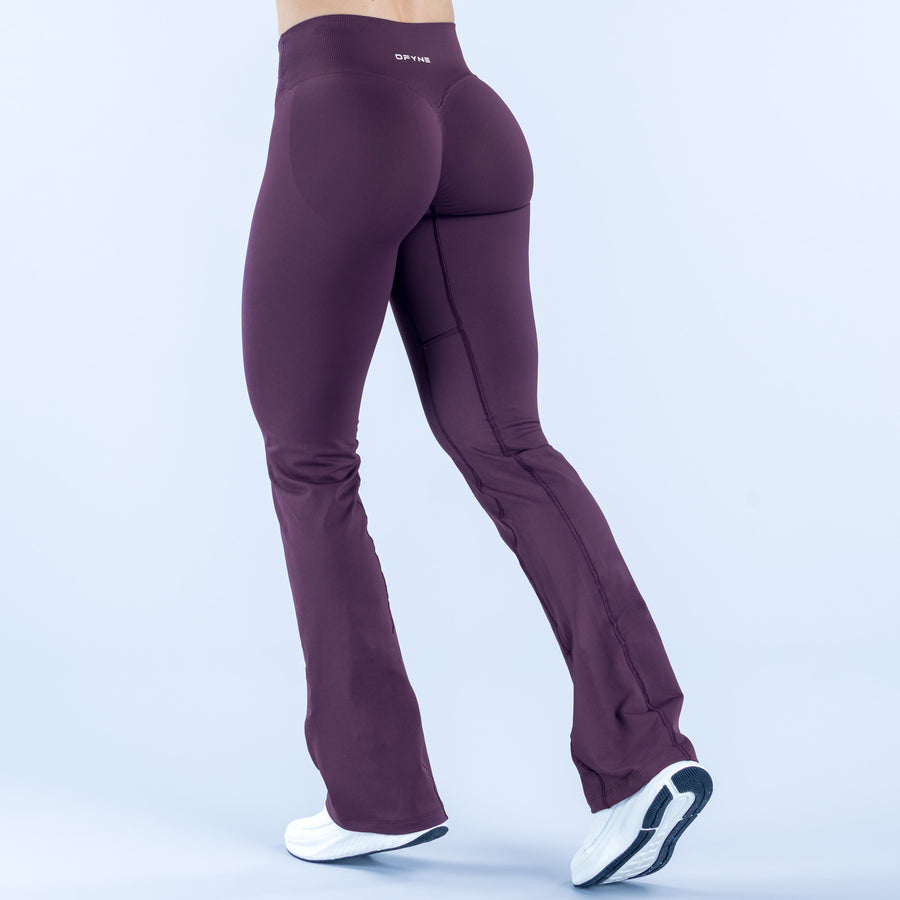 Purple flared leggings with curved seam panels and ankle-to-bootcut flare