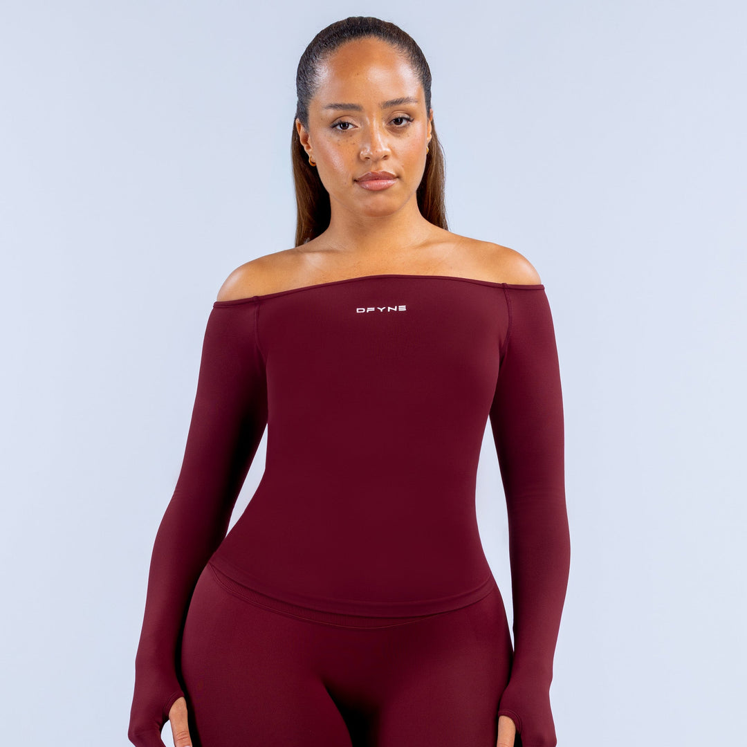 Burgundy fitted long-sleeve off-shoulder athletic top with small chest logo