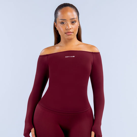 Burgundy fitted long-sleeve off-shoulder athletic top with small chest logo