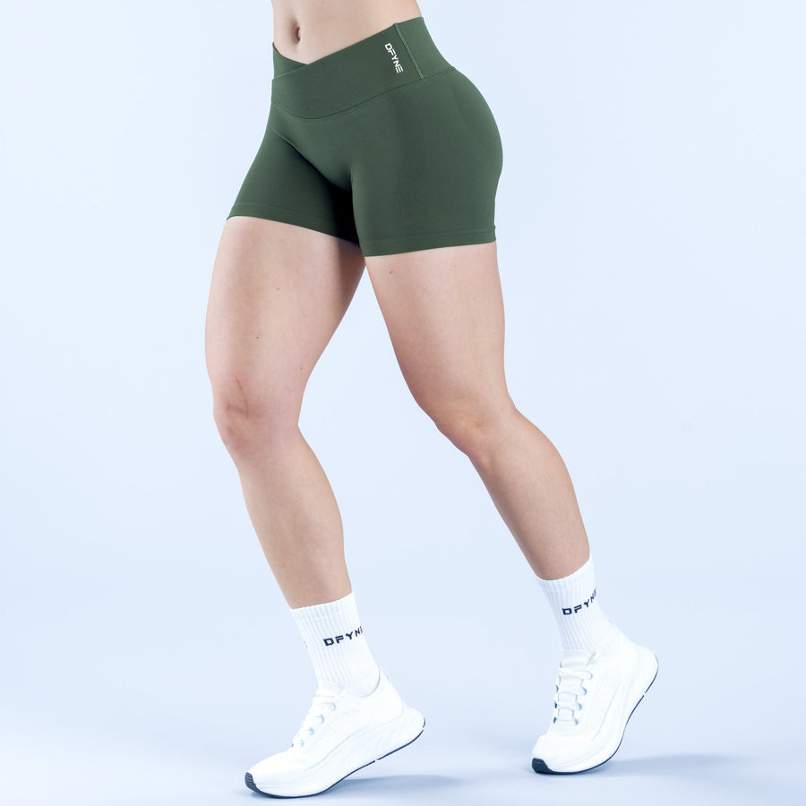 Dark green 4.5 in athletic shorts with small logo on waistband