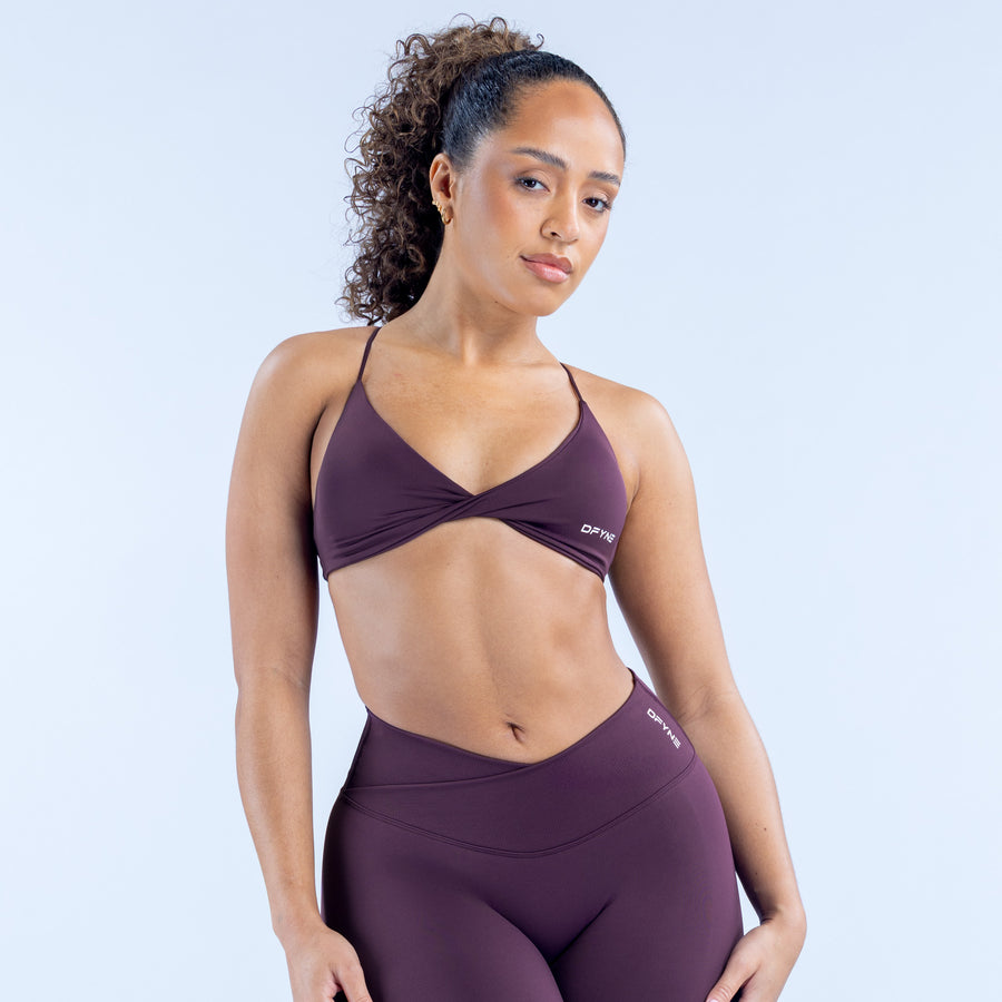Twist-front sports bra with V-neck, fitted cups, dark plum