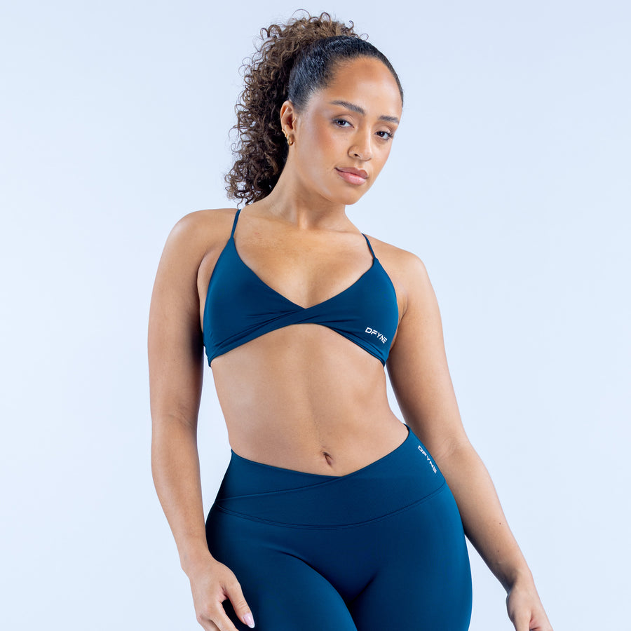 Twist-front sports bra in dark blue with V neckline and racerback straps