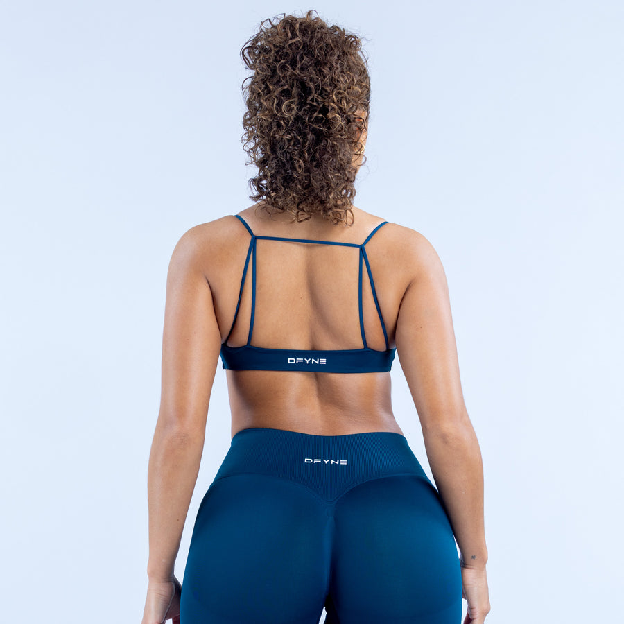 Strappy racerback sports bra in dark blue with elastic logo band