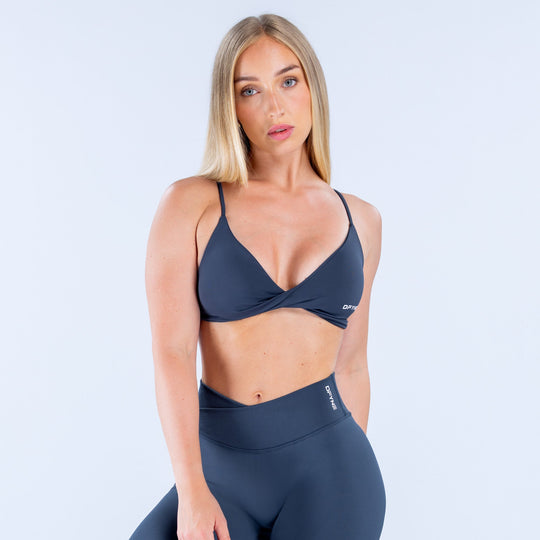 Navy twist-front sports bra with V-neck and thin adjustable shoulder straps
