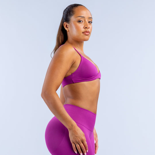 Purple twist-front sports bra with thin straps and supportive V-neck