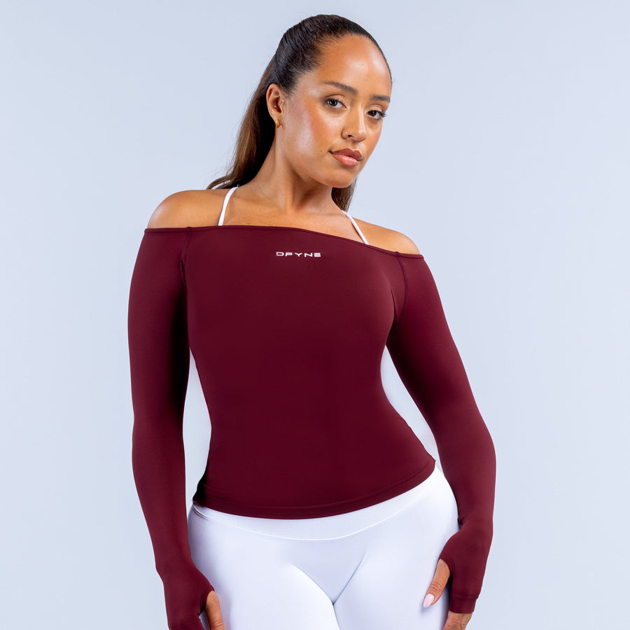 Burgundy fitted long-sleeve off-shoulder athletic top with small chest logo detail