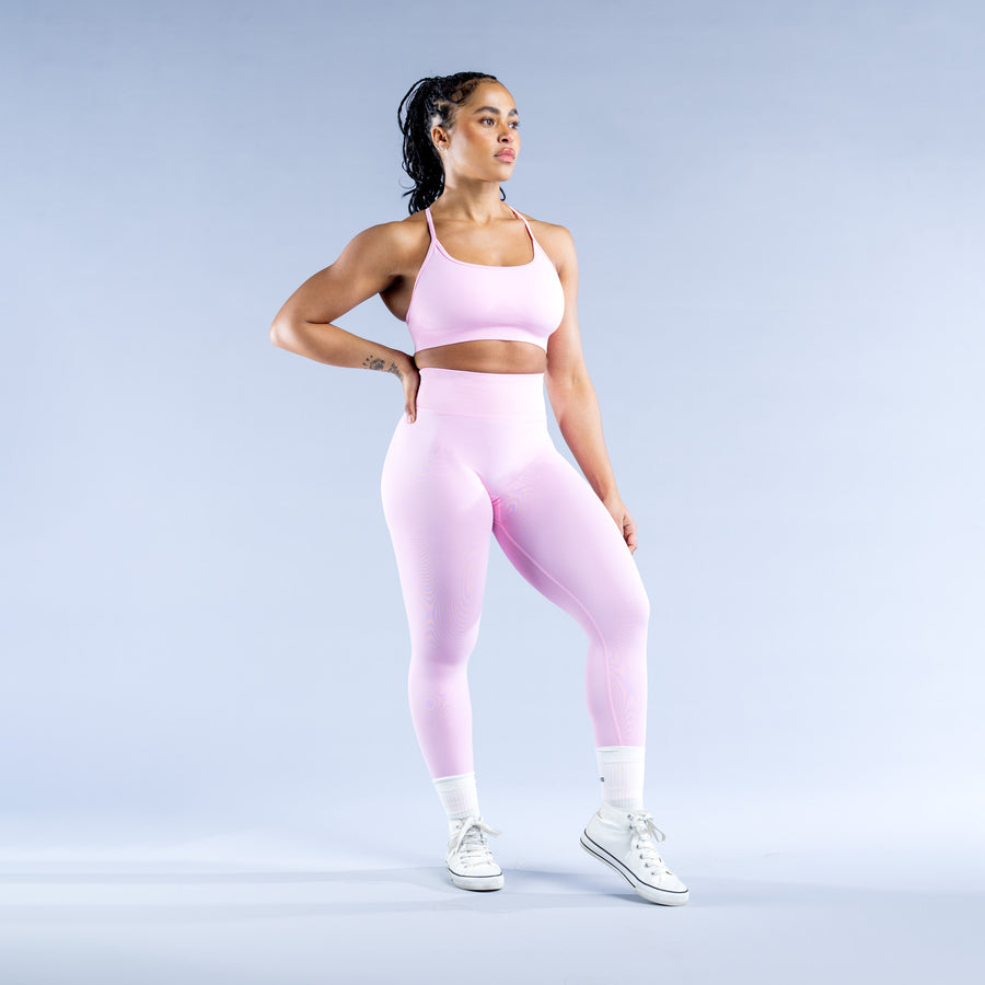 Backless sports bra with scoop neckline and thin straps, pale pink stretch fabric