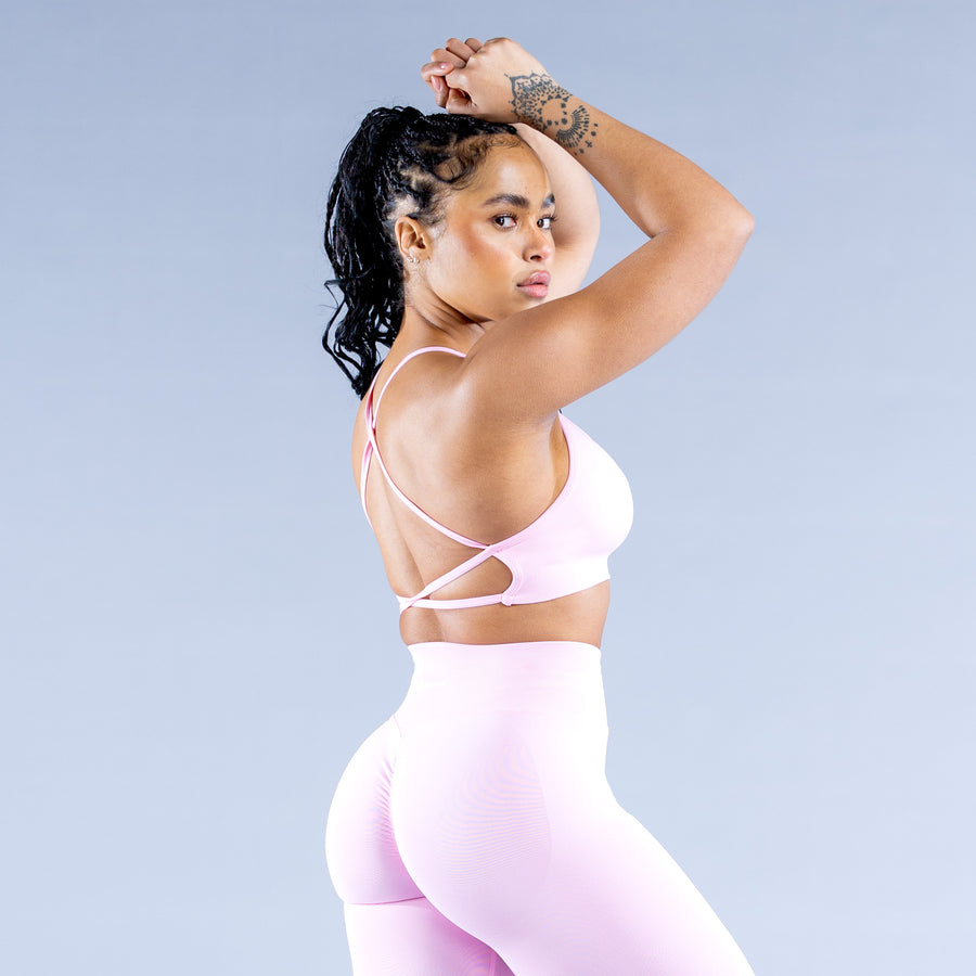 Backless sports bra with thin X-back straps and open back, pale pink
